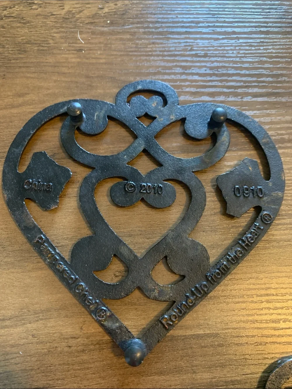 The Pampered Chef Copper-Tone Ornate Trivet Set.